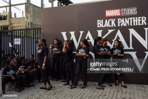 Crew members wait to assist guests during the African premiere of the film "Black Panther: Wakanda Forever" in Lagos, on November 6, 2022. - The...