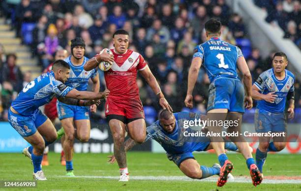 Tongas Moses Suli evades the tackle from Samoas Junior Paulo during the Rugby League World Cup quarter final match between Tonga and Samoa at The...