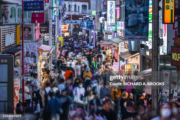 This photo taken on October 10, 2022 shows people walking down Takeshita Street in the Harajuku area of Tokyo. - The global population will breach...