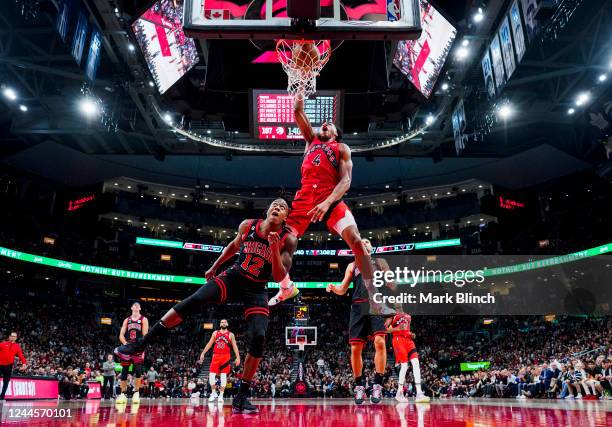 Scottie Barnes of the Toronto Raptors goes up for a slam dunk against Ayo Dosunmu of the Chicago Bulls during the second half of their basketball...