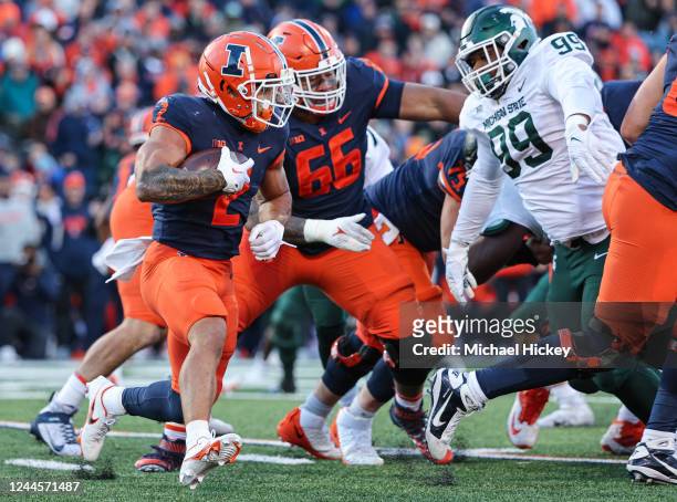 Chase Brown of the Illinois Fighting Illini runs the ball during the game against the Michigan State Spartans at Memorial Stadium on November 5, 2022...