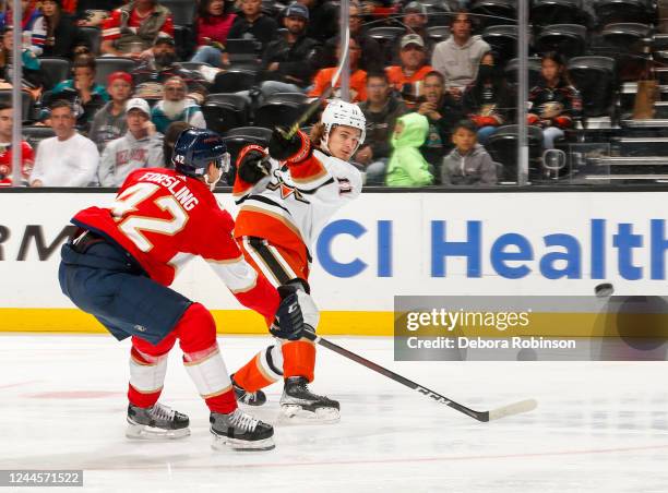 Trevor Zegras of the Anaheim Ducks passes the puck with pressure from Gustav Forsling of the Florida Panthers during the third period at Honda Center...