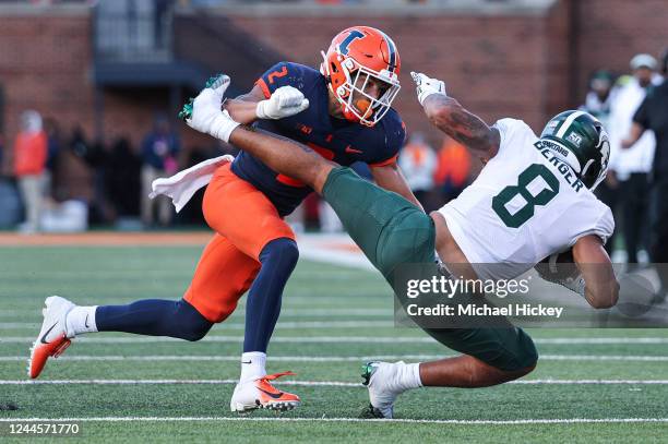 Matthew Bailey of the Illinois Fighting Illini makes the hit on Jalen Berger of the Michigan State Spartans during the second half at Memorial...