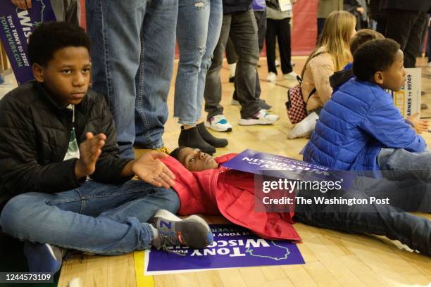 Children of Tyron Riddle of Racine, WI. From left to right: Cameron Riddle Mason Riddle and Brody Riddle listen as Wisconsin Governor Tony Evers...