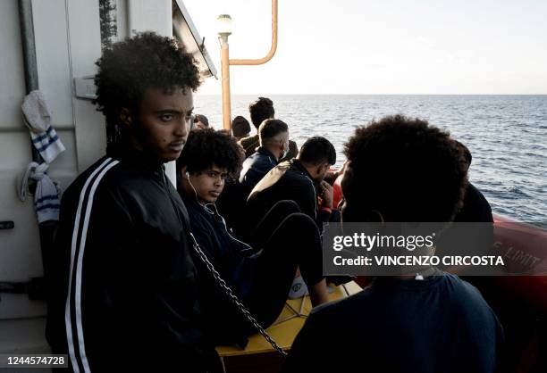 Migrants wait on the deck of the "Ocean Viking" rescue ship of European maritime-humanitarian organisation "SOS Mediterranee" in the Gulf of Catania...