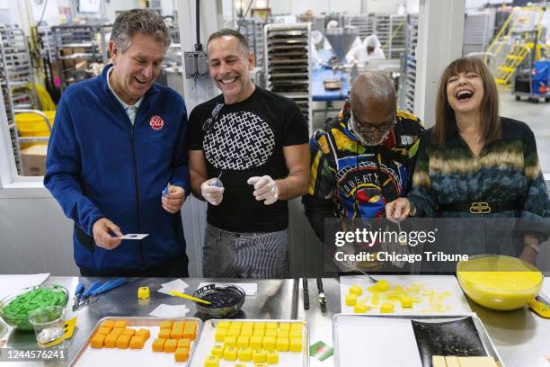 Eliâs Cheesecake Company owners Marc Schulman, left, and Maureen Schulman, right, work with Bob Faust, second from left, and Nick Cave on the...