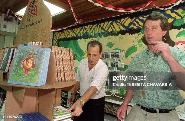 Robert Kennedy Jr., right, looks at books made from banana paper at the Agricultural School of the Nothern Tropics in Guacimo, Limon near San Jose,...