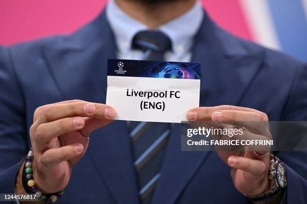 Champions League's ambassador Turkish former footballer Hamit Altintop shows the paper slip of Liverpool during the draw for the round of 16 of the...