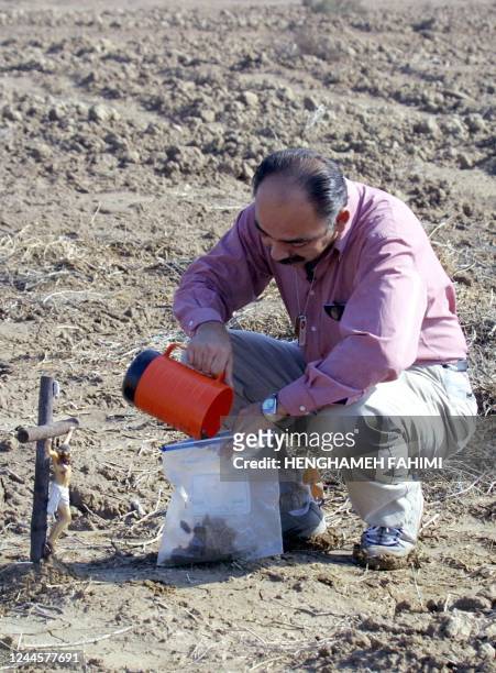 Fernando Suarez, from Escondido, CA, father of Jesus Suarez, a US soldier killed during the US-led war on Iraq in March 2003, collects soil from the...