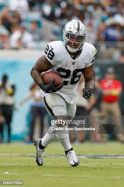 Las Vegas Raiders running back Josh Jacobs runs with the ball during the game between the Las Vegas Raiders and the Jacksonville Jaguars on November...