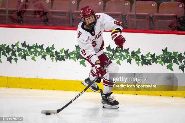 Harvard Crimson defenseman Ian Moore passes the puck during a college hockey game between the Brown Bears and the Harvard Crimson on November 4 at...