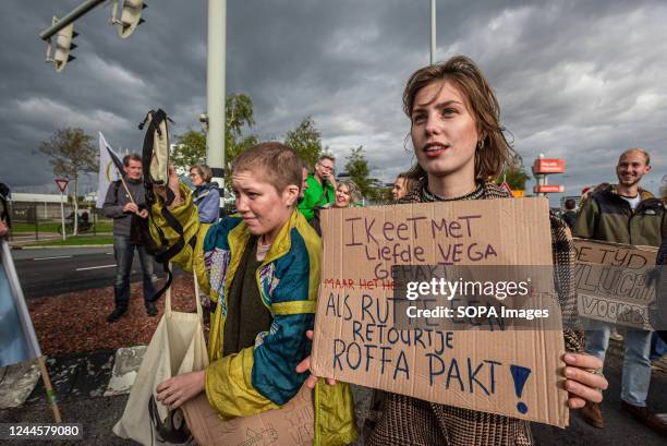 An activist holds a placard during the demonstration. More than 200 Extinction Rebellion and Greenpeace climate activists were arrested on Saturday...