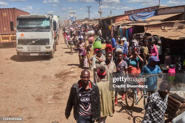 Informal traders alongside queues of trucks at the border crossing with the Democratic Republic of the Congo in Kasumbalesa, Zambia, on Saturday, May...