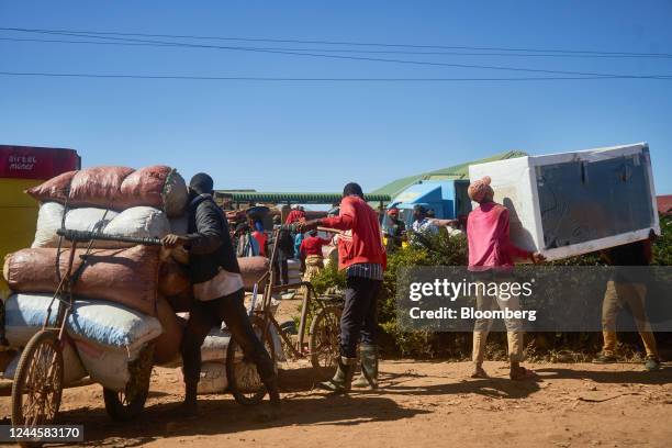 Informal traders carry goods at the border crossing with the Democratic Republic of the Congo in Kasumbalesa, Zambia, on Saturday, May 7, 2022. A...