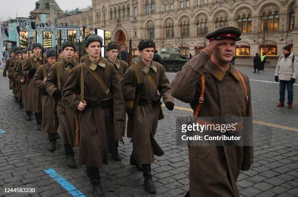Men in Soviet Army uniform march at the temporary historical exposition during the rally marking the anniversary of Bolshevik Revolution on November...