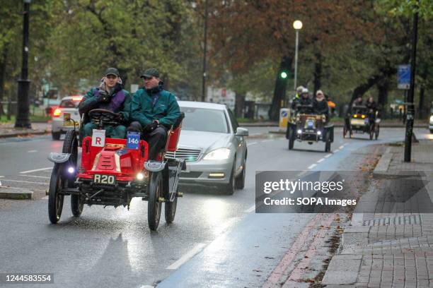 Participants seen on their 1903 De Dion Bouton Veteran Car as it rains during the run at Clapham Common. More than 350 veteran cars took part in the...