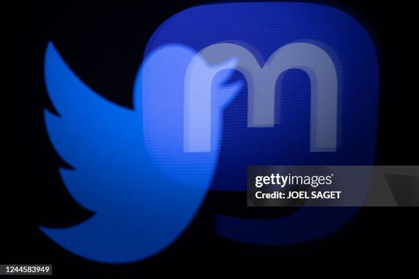 This photograph taken on November 7, 2022 shows the logos of social networks Twitter and Mastodon reflected in smartphone screens, in Paris.