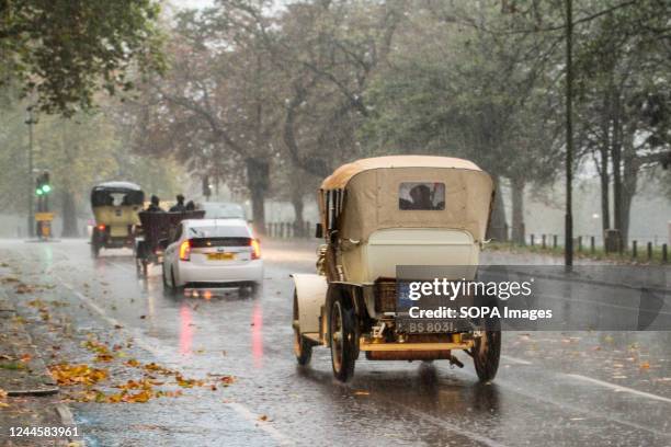 Mercedes veteran car follows local traffic through South London traffic in the rain. More than 350 veteran cars took part in the annual RM Sothebys...