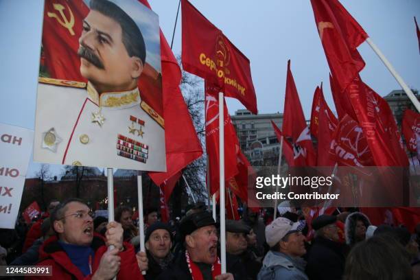 Russian Communists Party supporters with Soviet flags and portrait of former Soviet Leader Joseph Stalin shout slogans during the rally marking the...