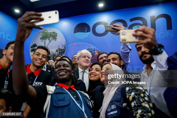 Boris Johnson, former Prime Minister of the UK poses for selfie photographs with volunteers in Oceans Pavilion on the second day of the COP27 UN...