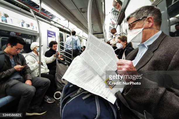 Commuters in a subway in New York, United States, on October 25, 2022.