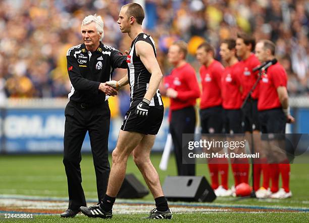 Michael Malthouse coach of the Magpies wishes his captain Nick Maxwell the best of luck at the start of the AFL First Qualifying match between the...