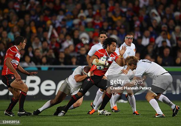 Kosuke Endo of Japan tries to find a way past Aurelien Rougerie of France during the IRB 2011 Rugby World Cup Pool A match between France and Japan...