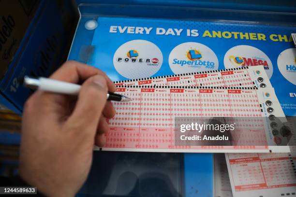Person plays Powerball lottery at a 7-Eleven store in Milpitas, California, United States on November 7, 2022. Today's Powerball jackpot hits a...