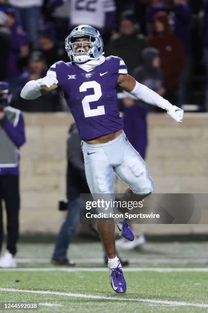 Kansas State Wildcats safety Kobe Savage leaps to celebrate a big third down stop late in the fourth quarter of a Big 12 college football game...