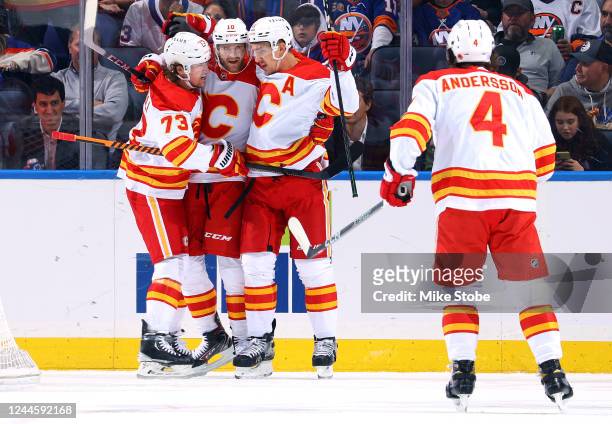 Mikael Backlund of the Calgary Flames is congratulated by his teammates after scoring a goal against the New York Islanders during the first period...