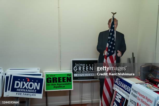 Cutout of former President Donald Trump is seen near stacks of signs in the office of the Lapeer Country Republican Party on Monday, Oct. 17, 2022 in...