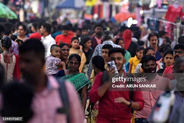 In this photograph taken on October 31 people walk through a crowded commercial street in Chennai. - India is projected to see an explosion in its...
