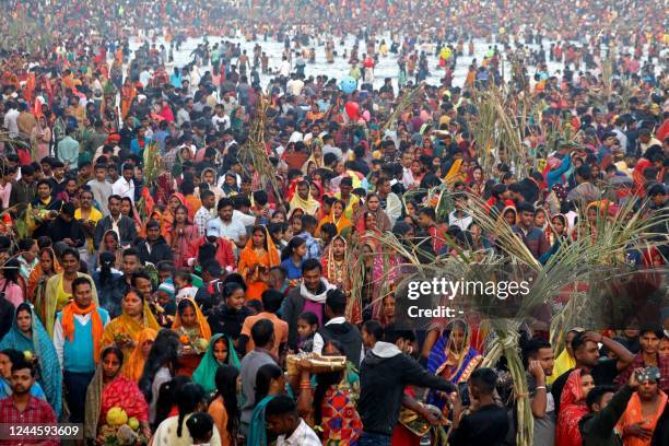 In this photograph taken on October 31 devotees take part in a ritual to worship the sun during the Hindu festival of Chhath Puja at a lake in...