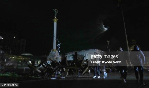 People walk in almost total darkness during a power outage in Ukraine's capital Kyiv on Nov. 2 after Russian missile and drone strikes damaged energy...