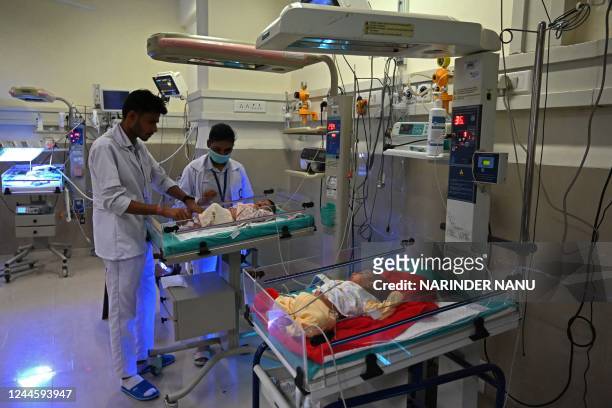 In this photograph taken on October 13 newborn babies lay on radiant warmers inside a special newborn care unit at a hospital in Amritsar. - India is...
