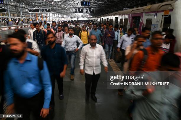 In this photograph taken on November 4 commuters alight from a suburban train at the Chhatrapati Shivaji Maharaj Terminus railway station in Mumbai....