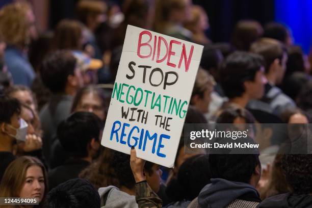 An Iranian human rights activist holds up a sign during a rally attended by Vice President Kamala Harris for Los Angeles mayoral candidate, U.S. Rep....