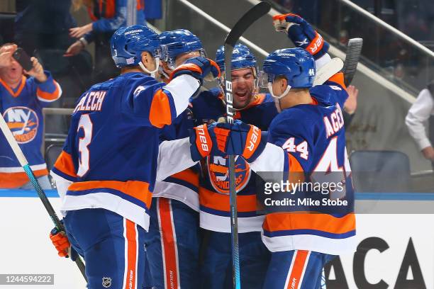 Kyle Palmieri of the New York Islanders is congratulated by his teammates after scoring a goal against the Calgary Flames during the third period at...