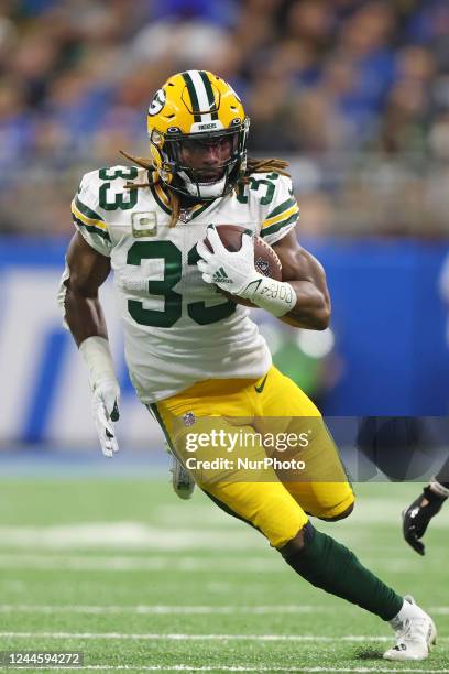 Green Bay Packers running back Aaron Jones runs the ball during the first half of an NFL football game against the Detroit Lions in Detroit, Michigan...