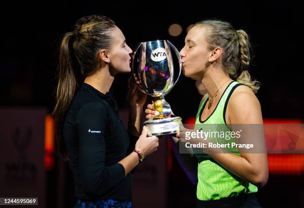 Veronika Kudermetova of Russia and Elise Mertens of Belgium pose with their champions trophy after defeating Barbora Krejcikova of the Czech Republic...