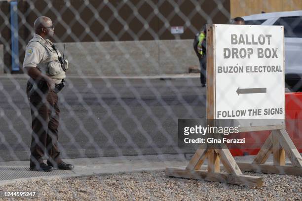 Phoenix, AZ A security guard watches over a ballot drop box on Monday, Nov. 7, 2022 in Phoenix, AZ.