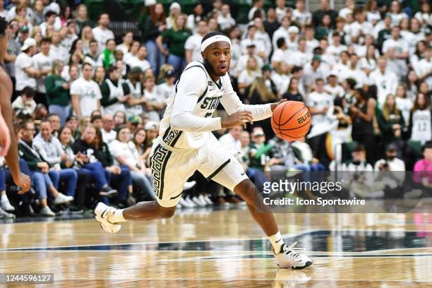 Michigan State Spartans guard Tre Holloman dribbles at the top of the key during a college basketball game between the Michigan State Spartans and...