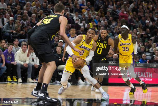 Russell Westbrook of the Los Angeles Lakers drives to the basket against Walker Kessler and Talen Horton-Tucker of the Utah Jazz as teammate Wenyen...