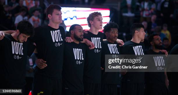 Members of the Utah Jazz wear Vote tshirts as they stand in line for the National Anthem before their game against the Los Angeles Lakers at the...