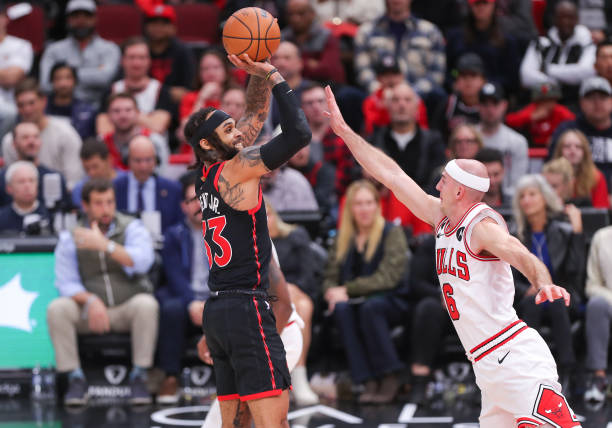 Toronto Raptors guard Gary Trent Jr. Shoots the ball over Chicago Bulls guard Alex Caruso during a NBA game between the Toronto Raptors and the...