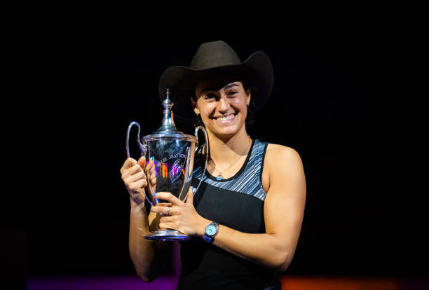 Caroline Garcia of France poses with the champions trophy after defeating Aryna Sabalenka of Belarus in the singles final match on Day 8 of the 2022...