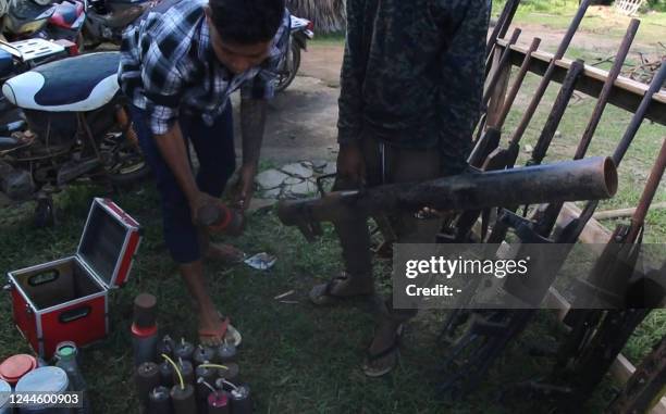 This screengrab from AFPTV video footage taken on October 15, 2022 shows members of the People Revolution Army preparing homemade weapons in Pale...