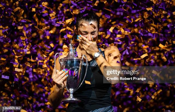 Caroline Garcia of France poses with the champions trophy after defeating Aryna Sabalenka of Belarus in the singles final match on Day 8 of the 2022...