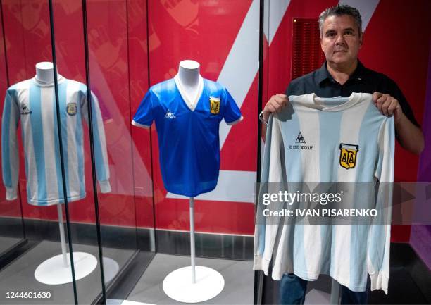 Argentinian football fan and collector Javier Maluf poses in Doha on October 4, 2022 with the jersey worn by Diego Maradona during a friendly match...