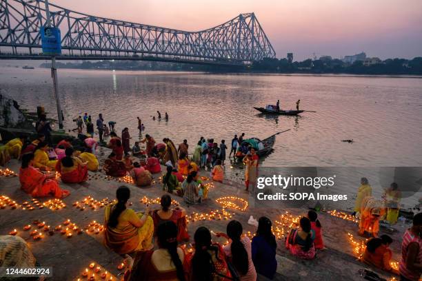 Devotees are waiting to perform rituals in the late afternoon on the banks of the river Ganges during the occasion. Devotees light oil lamps,...